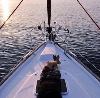 man lying on white boat